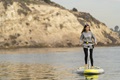 A lady using the Hobie iEclipse stand up inflatable board