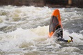 A paddler going vertical with the Pyranha Firecracker on a river