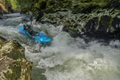 A paddler using the Pyranha Scorch kayak in river rapids