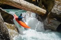 A paddler going down a whitewater drop in the Pyranha Scorch X kayak