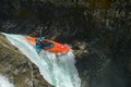 A paddler dropping down a whitewater fall in the Pyranha Scorch X kayak